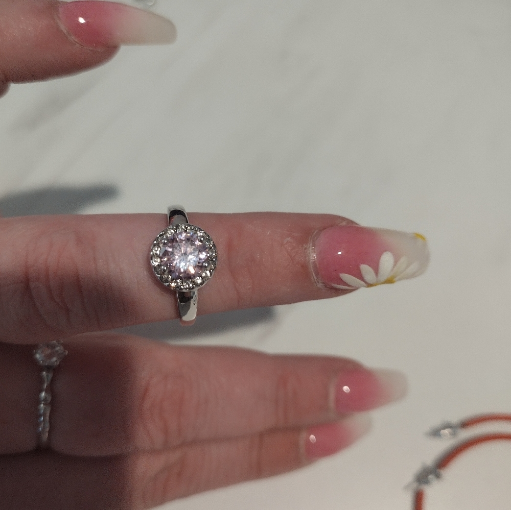 This is a beautiful silver with pink diamond ring